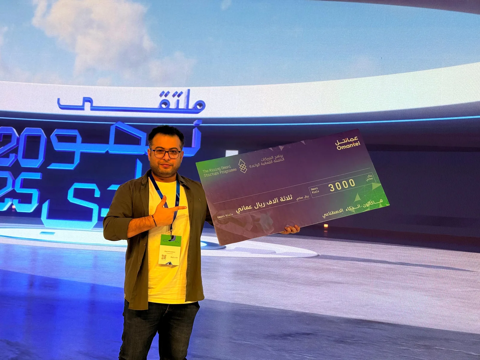 Milad Ahmadipour holding the first-place Omantel AI Hackathon 2025 award cheque